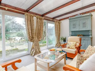 a living room with a couch and a table at 2 Bed in Newquay oc-82370 in Mitchell