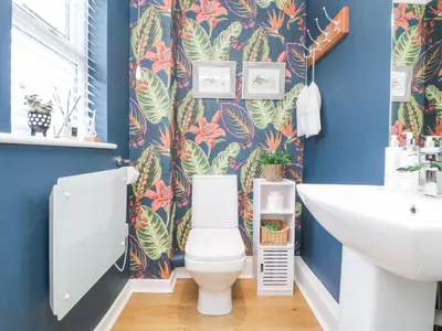 a bathroom with a toilet and a sink at Breeze Cottage in Falmouth