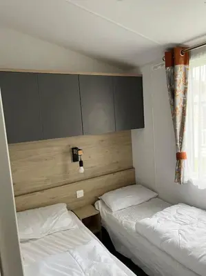 a room with two beds and a window in it at The Cornish hottub escape in St Austell