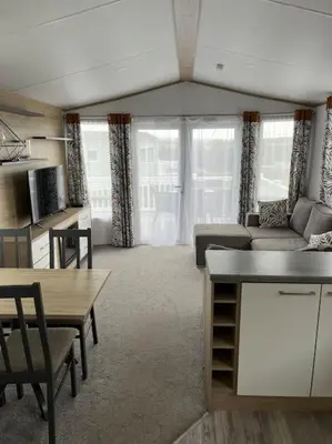 a living room with a couch and a table at The Cornish hottub escape in St Austell