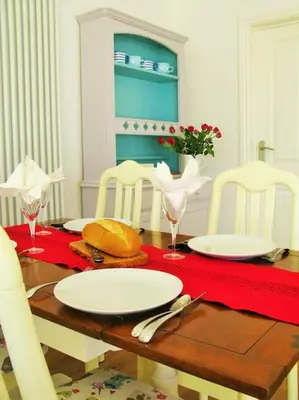 a wooden table with white plates on top of it at Sunny Corner - Coastal apartment near the beach in Crantock