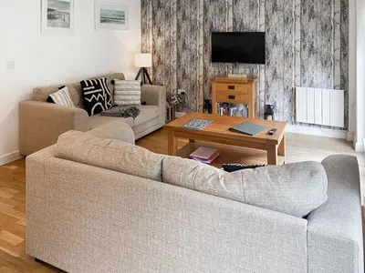 a living room with a couch and a coffee table at Trebellan in Porthtowan