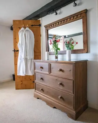 a dresser with a mirror on top of it at Treworgie Barton - Duchy in Bude