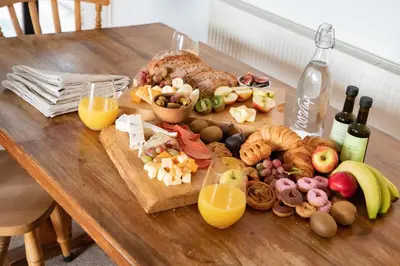 a wooden table with a variety of food and drinks at Treworgie Barton - Duchy in Bude
