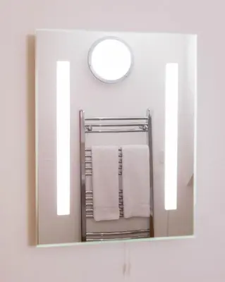 a mirror in a bathroom with towels on a rack at Treworgie Barton - Butterwell in Bude