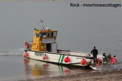 a yellow and white boat sitting on the beach at Bryher in Wadebridge