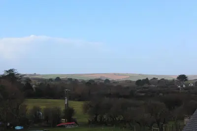 a view of a field with trees and hills at Bryher in Wadebridge