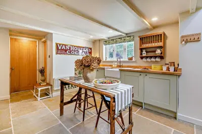 a kitchen with a table with a vase on it at 3 Bed in Germoe oc-w29163 in Germoe