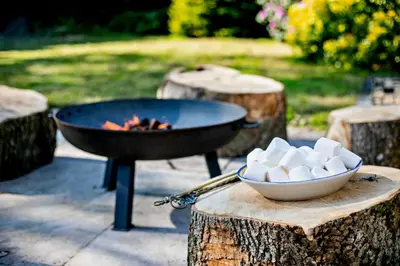 a grill with a bowl of marshmallows next to a bowl of fire at 3 Bed in Germoe oc-w29163 in Germoe