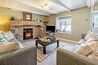 a living room with two couches and a fireplace at 3 Bed in Germoe oc-w29163 in Germoe