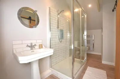 a white bathroom with a sink and a shower at 3 Bed in Germoe oc-w29163 in Germoe