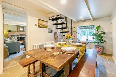 a dining room with a wooden table and a book shelf at 3 Bed in Germoe oc-w29163 in Germoe