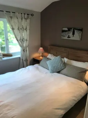 a bedroom with a large white bed with a window at No 63 Atlantic reach in Newquay