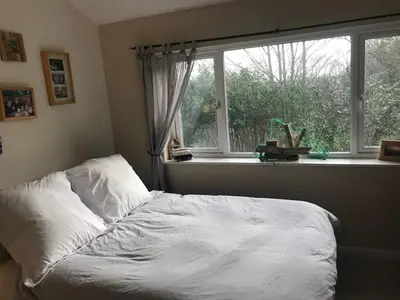 a bedroom with a white bed and a window at No 63 Atlantic reach in Newquay