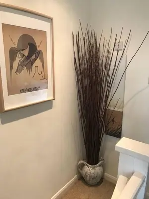 a vase sitting next to a picture on a wall at No 63 Atlantic reach in Newquay