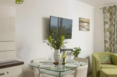 a dining room with a glass table and chairs at 17 Astor Court, Newquay in Newquay