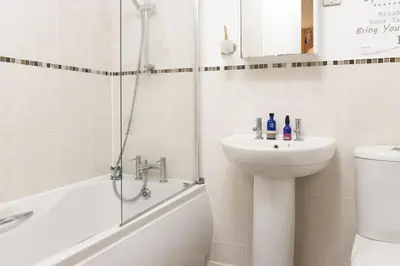a bathroom with a sink and a toilet and a shower at 17 Astor Court, Newquay in Newquay
