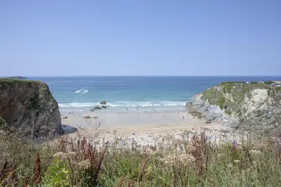 a group of people on a beach near the ocean at 17 Astor Court, Newquay in Newquay
