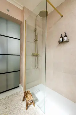 a shower with a glass door in a bathroom at no.five Flushing in Flushing