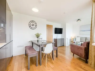 a living room with a table and a couch at Pegasus in Falmouth