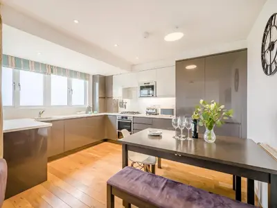 a kitchen with a table and a dining room at Pegasus in Falmouth