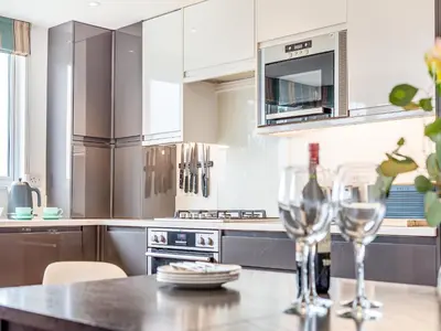 a kitchen with two wine glasses on a table at Pegasus in Falmouth