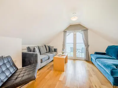 a living room with two couches and a window at Pegasus in Falmouth