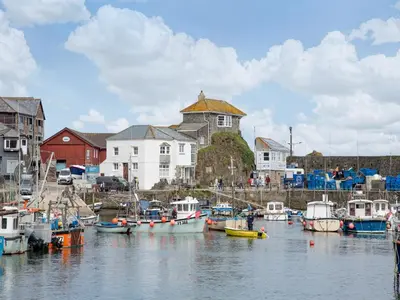 a group of boats are docked in a harbor at Spa Cottage in Mevagissey