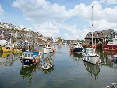 a group of boats are docked in a harbor at Spa Cottage in Mevagissey