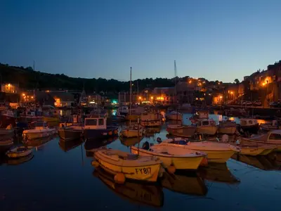 a group of boats docked in a harbor at night at Spa Cottage in Mevagissey