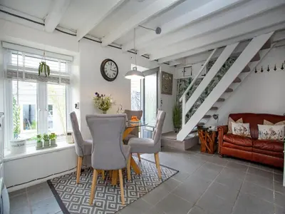 a dining room with a table and chairs at Spa Cottage in Mevagissey