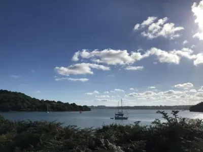 a boat in the water on a lake at Blue Cottage - 3 bedroom cottage in Feock in Feock