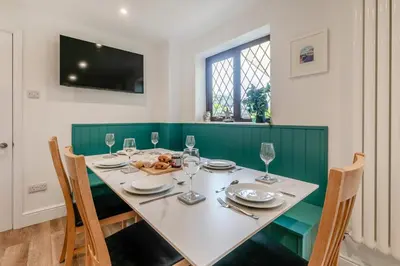 a dining room with a table with chairs and a television at 3 Bed in Padstow oc-p29061 in Padstow
