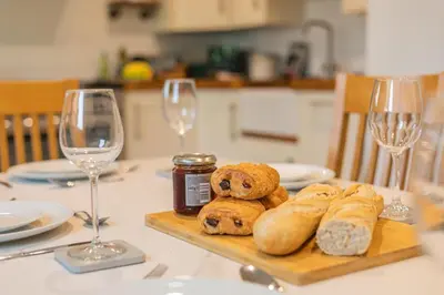 a table with a plate of bread and wine glasses at 3 Bed in Padstow oc-p29061 in Padstow
