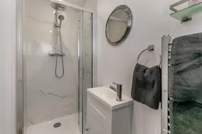 a white bathroom with a shower and a sink at 3 Bed in Padstow oc-p29061 in Padstow
