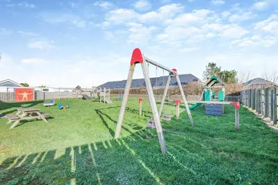a playground with a slide in the grass at 3 Bed in St. Merryn oc-l29062 in St Merryn