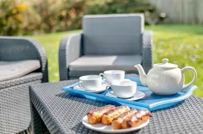a tray of donuts and tea cups on a table at 3 Bed in St. Merryn oc-l29062 in St Merryn