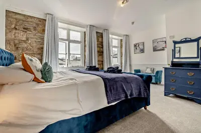a bedroom with a large bed and a blue dresser at 7 Bed in St. Agnes oc-p28968 in St. Agnes