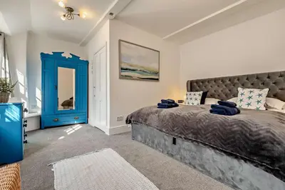a bedroom with a large bed and a blue door at 7 Bed in St. Agnes oc-p28968 in St. Agnes