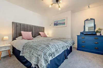 a bedroom with a bed with a blue dresser and a mirror at 7 Bed in St. Agnes oc-p28968 in St. Agnes