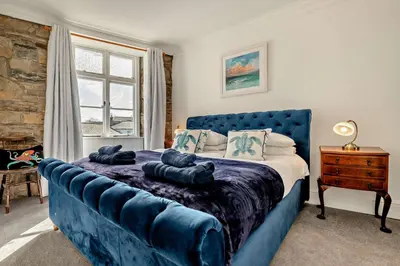 a bedroom with a blue bed with a blue couch at 7 Bed in St. Agnes oc-p28968 in St. Agnes