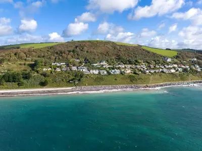 an aerial view of a beach with houses on a hill at 2 Bed in Downderry oc-p29018 in Downderry