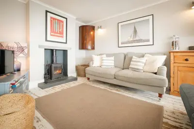 a living room with a couch and a fireplace at 2 Bed in Downderry oc-p29018 in Downderry