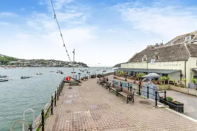 a pier with benches next to the water with boats at 2 Bed in Fowey oc-m29077 in Fowey