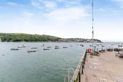 a group of boats in the water near a pier at 2 Bed in Fowey oc-m29077 in Fowey