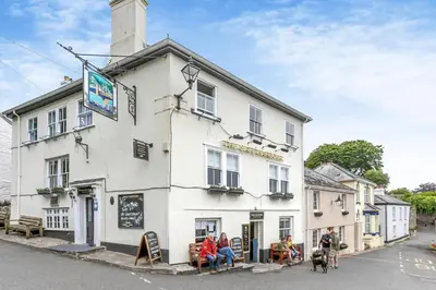 a white building with people sitting outside of it at 2 Bed in Fowey oc-m29077 in Fowey