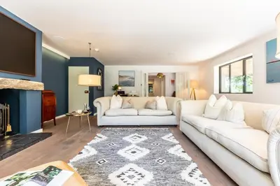 a living room with a white couch and a fireplace at 5 Bed in Little Petherick oc-s29057 in Little Petherick