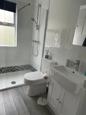 a white bathroom with a toilet and a sink at Little Jem Harlyn Bay near 7 Bays in St Merryn