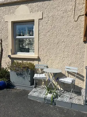 two tables and two chairs in front of a window at Little Jem Harlyn Bay near 7 Bays in St Merryn