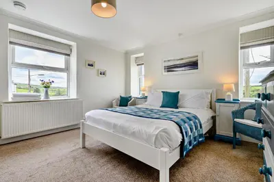 a bedroom with a bed and two windows at 3 Bed in Treknow oc-h29194 in Treknow